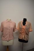 Two 1950s pink blouses, one of pink crepe with cut work and machine embroidery to collar and