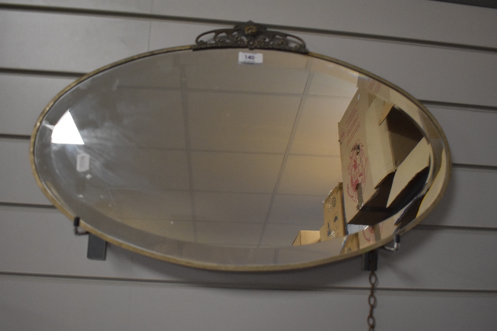 A vintage Art Deco style bevelled wall mirror 61cm x 38cm.