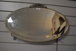 A vintage Art Deco style bevelled wall mirror 61cm x 38cm.