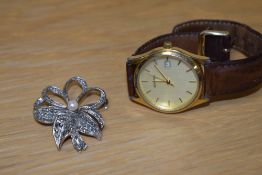 A gentleman's Sekonda wristwatch along with a floral design marcasite and pearl brooch.