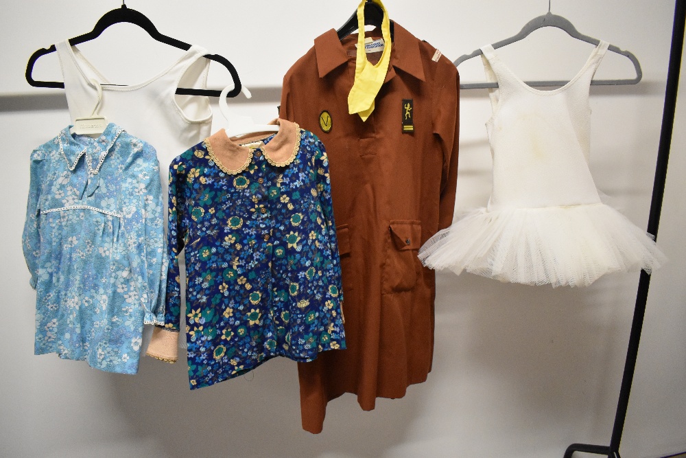 Two 1960s floral infants dresses, two tutus and a girl guides uniform.