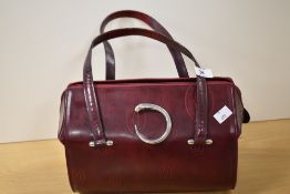 A red leather fashion handbag with Cartier style design