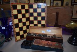 A vintage Draughts board and interlocking Draughtsmen and an ornately boxed set of wooden Dominoes.