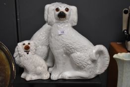 Two Staffordshire pottery dogs and a similar smaller example.