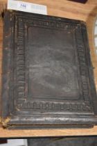 A Victorian leather bound photo album with floral page mounts.