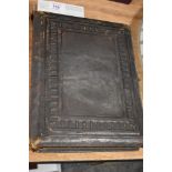 A Victorian leather bound photo album with floral page mounts.