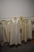 Three antique babies gowns (some AF, darns etc) a bonnet, an early 20th century coat and an adults