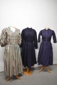 Three vintage dresses, including bohemian style full length dress, navy blue dirndl dress and navy