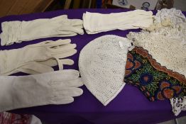 An assortment of antique lace collars and panels, caps and vintage gloves.