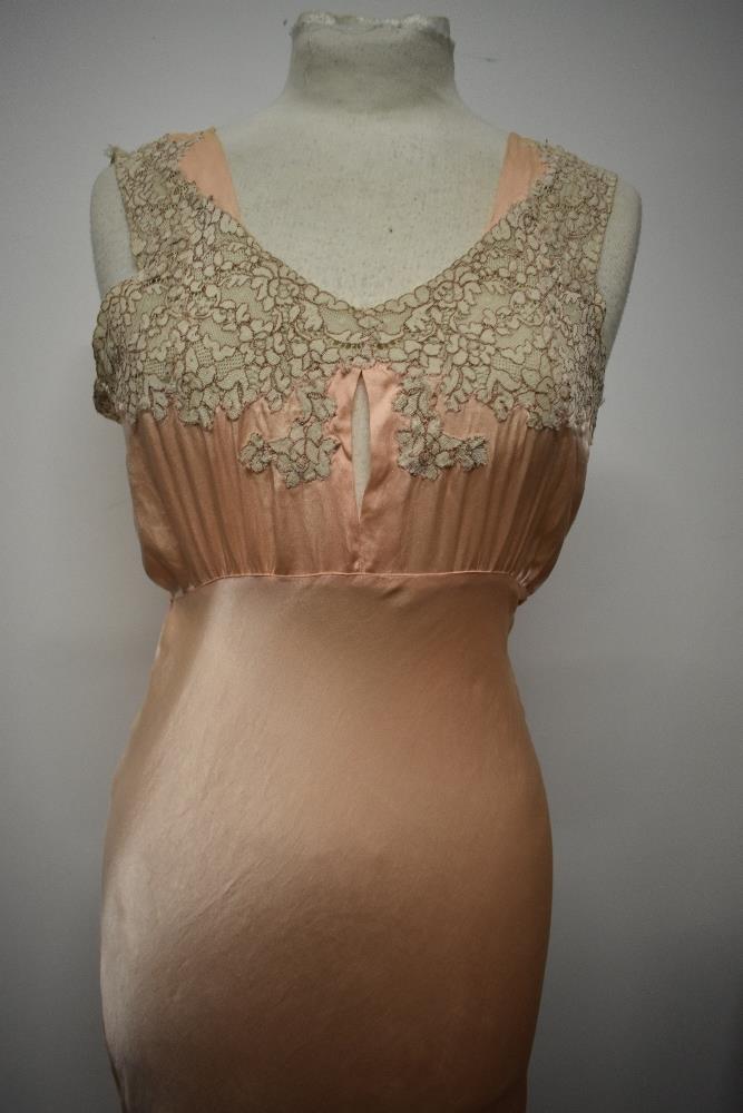 An Art Deco pale pink bias cut nightdress, having beautiful lace to bodice and hem, tie fastening to - Image 3 of 14