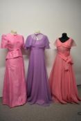 A 1950s pink evening gown with full skirt, a 1960s pink gown with bows to bodice and a 1970s John