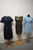 Three 1960s dresses, including two with metallic thread accents and baby blue mini dress with puff