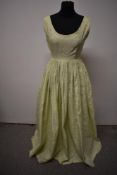 A pale green 1950s evening gown, having scoop neckline and full skirt.