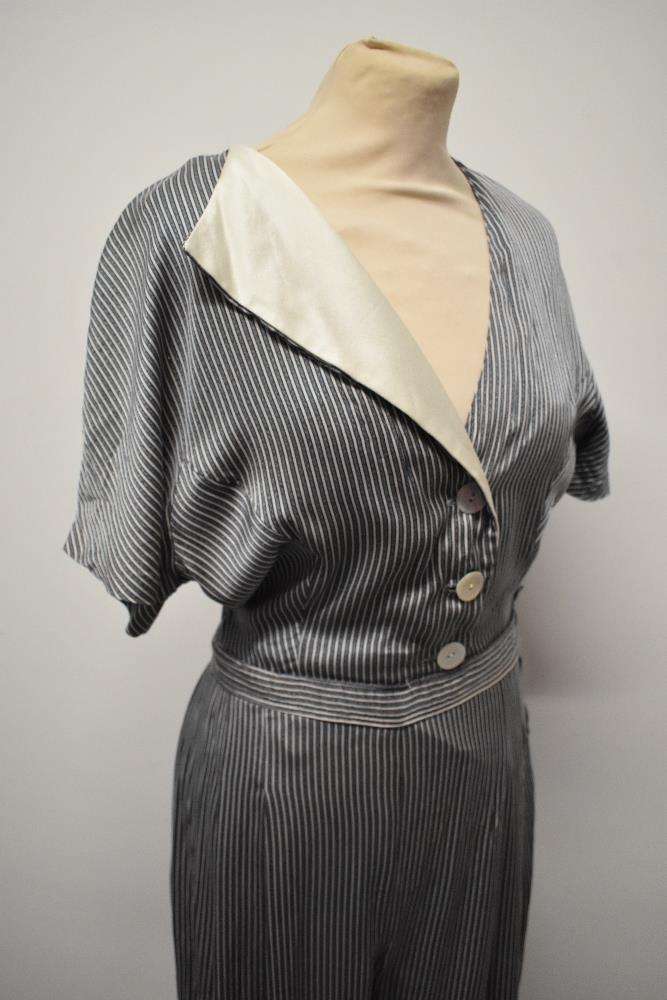 A silky striped vintage jump suit, having contrasting lapel and wide legs. - Image 2 of 7