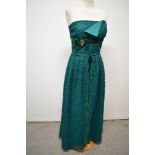 A 1950s / 1960s emerald green lace evening gown, having strapless bodice with velvet bow and