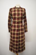 A 1940s plaid day dress, in burgundy, fawn and chestnut brown, having long sleeves, wooden buttons