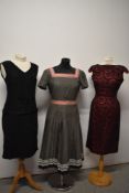 Two 1960s dresses, one with pleated skirt and bold dot pattern and a 1950s lace dress with red