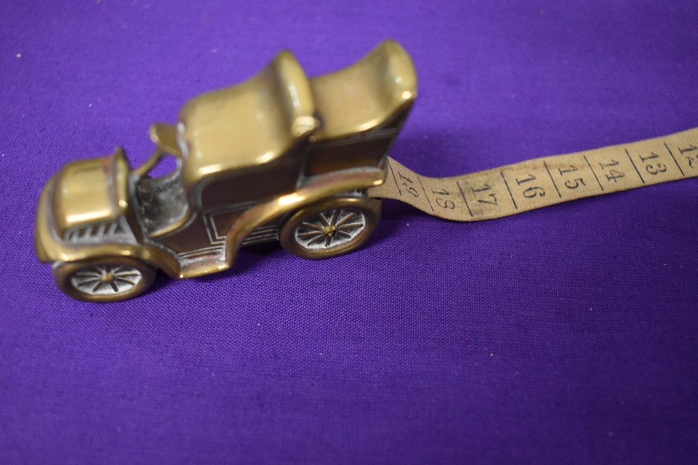 An Edwardian brass measuring tape in the form of a car. - Image 4 of 5