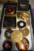 Eleven vintage compacts, including statue of Liberty compact and one having fuchsia decoration.