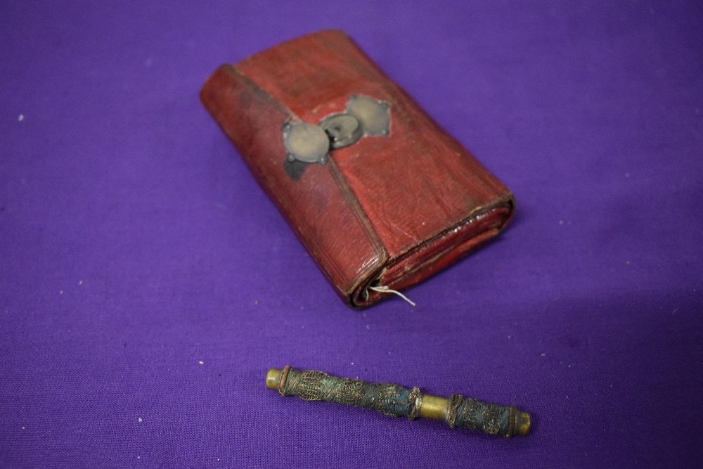 A Victorian green and red leather needle case and an 18th/19th century needle case.