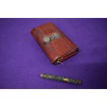 A Victorian green and red leather needle case and an 18th/19th century needle case.