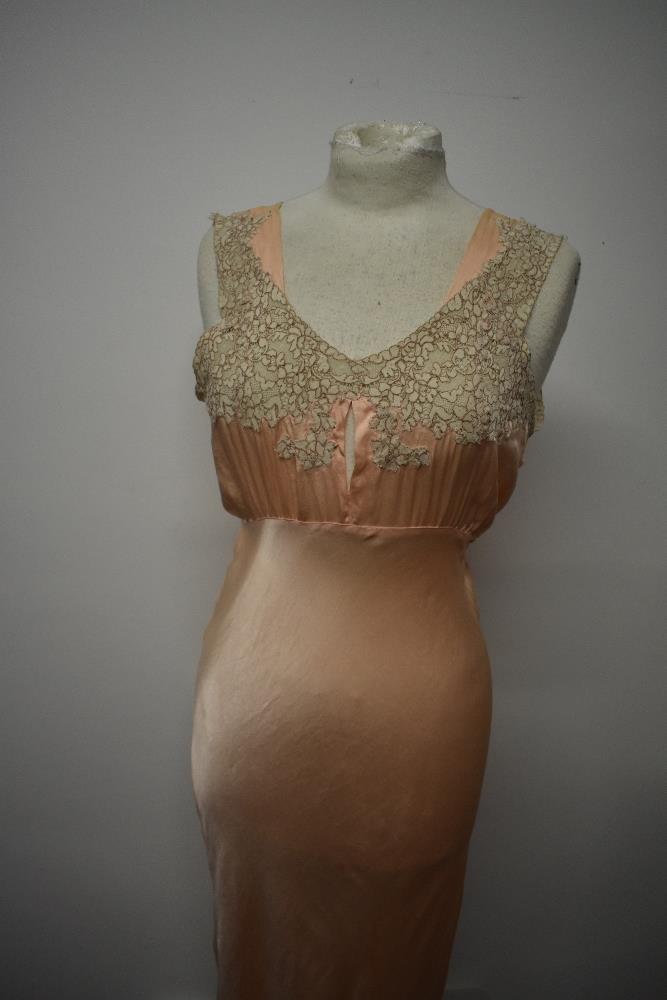 An Art Deco pale pink bias cut nightdress, having beautiful lace to bodice and hem, tie fastening to - Image 9 of 14