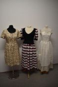 Three vintage dresses, including bright floral dress with contrasting black faux waistcoat.