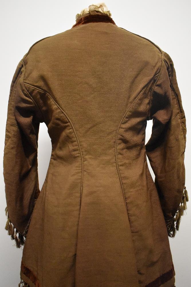 A Brown Victorian overcoat, having velvet trim, tassels to hem and sleeves and silk bow details ( - Image 4 of 17