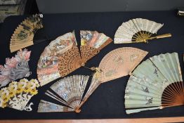 A collection of damaged fans, some particularly old ones among the collection, ribs and parts may be