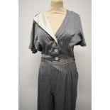 A silky striped vintage jump suit, having contrasting lapel and wide legs.