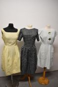 Three vintage dresses, to include 1950s day dress of textured cotton with large green buttons to