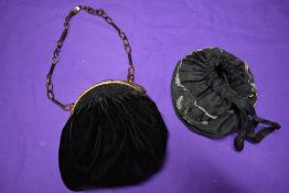 Two antique bags, one drawstring having beadwork and the other of black velvet with moulded frame,