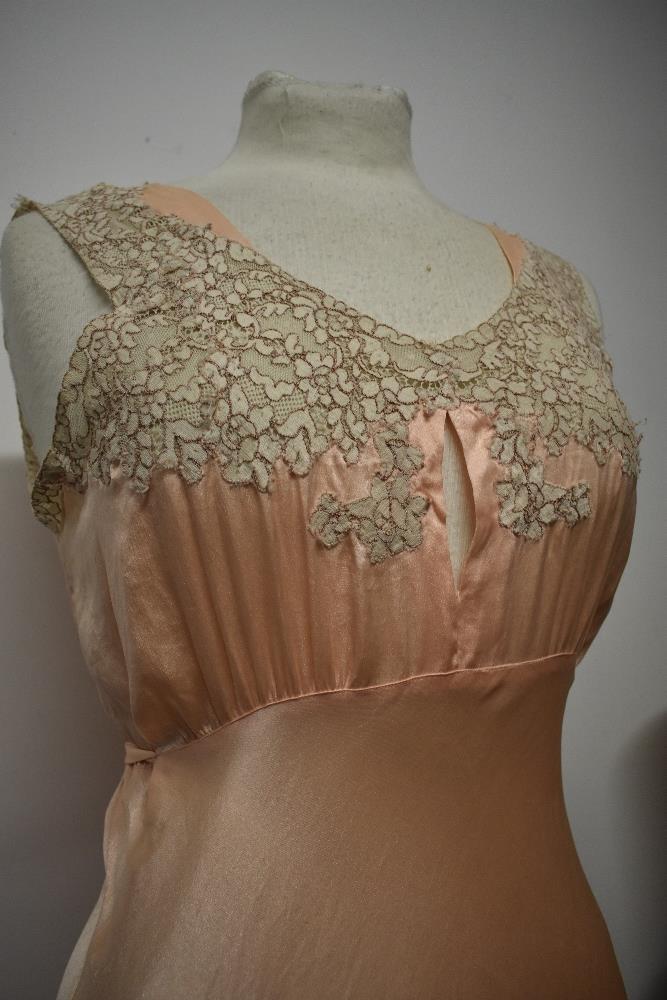 An Art Deco pale pink bias cut nightdress, having beautiful lace to bodice and hem, tie fastening to - Image 4 of 14