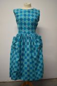 A 1950s turquoise blue cotton day dress, with patch pockets to front, gathered skirt and side