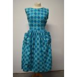 A 1950s turquoise blue cotton day dress, with patch pockets to front, gathered skirt and side