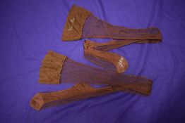 A scarce pair of brown early 20th century seamed fishnet stockings, having reinforced heel and