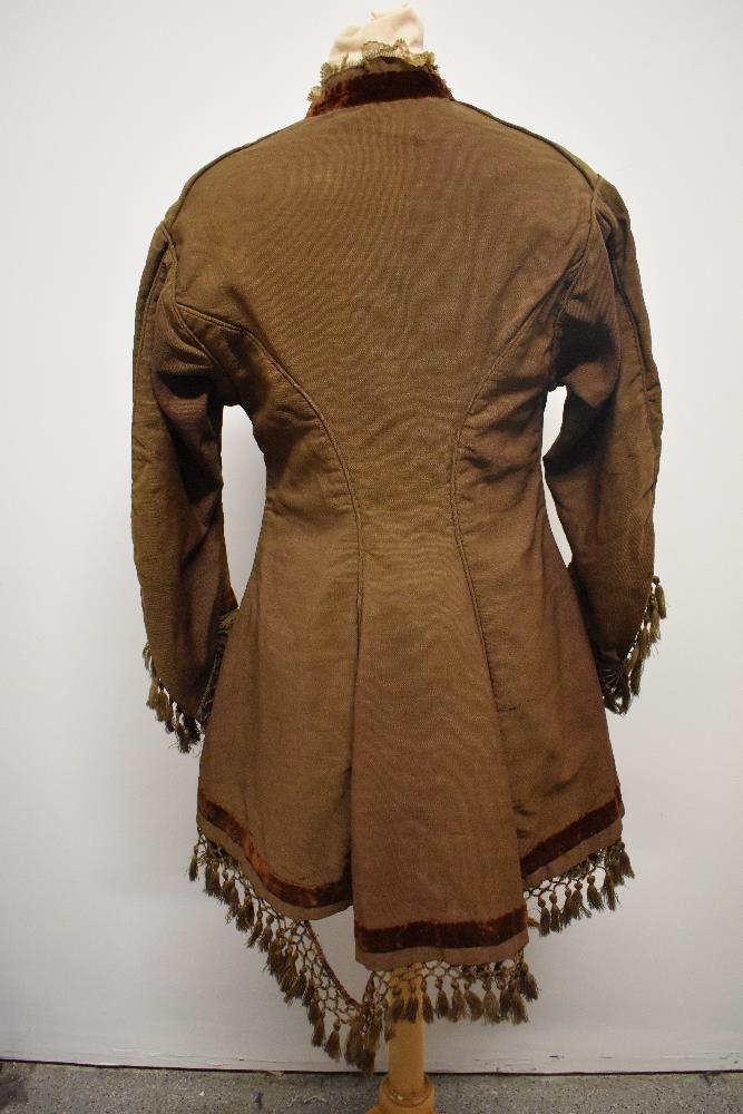 A Brown Victorian overcoat, having velvet trim, tassels to hem and sleeves and silk bow details ( - Image 5 of 17