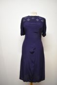 A 1940s floppy navy blue rayon or similar day dress, having soutache style braiding to bodice and