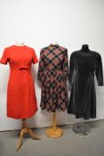 Three vintage dresses, including red, blue, green, blsck and white plaid day dress with pleated
