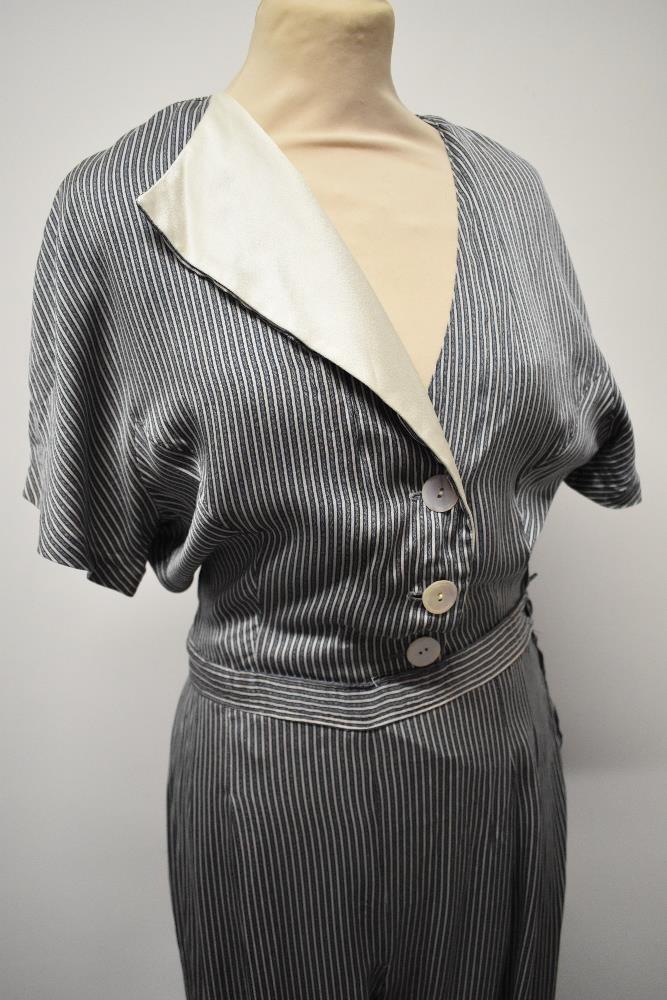 A silky striped vintage jump suit, having contrasting lapel and wide legs. - Image 6 of 7