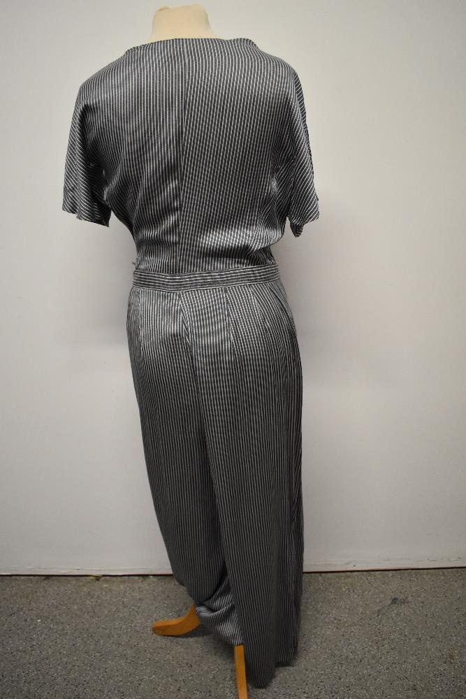 A silky striped vintage jump suit, having contrasting lapel and wide legs. - Image 4 of 7