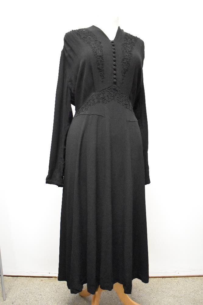 A late 1930s / 1940s black crepe day dress, having braiding to front with sequins, panelled skirt,