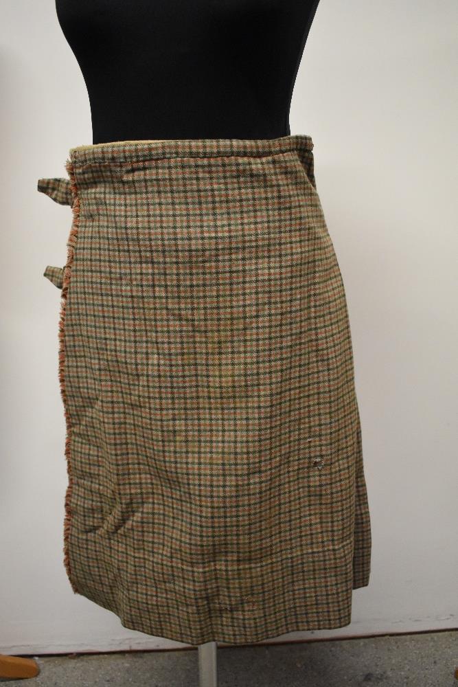 An antique kilt, some repair and nips in places, partially lined in a natural calico fabric.
