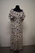 A 1930s day dress, having abstract leaf pattern, beautiful fluted sleeves and amazing panelling to