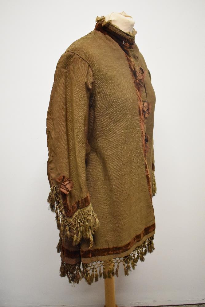 A Brown Victorian overcoat, having velvet trim, tassels to hem and sleeves and silk bow details ( - Image 16 of 17