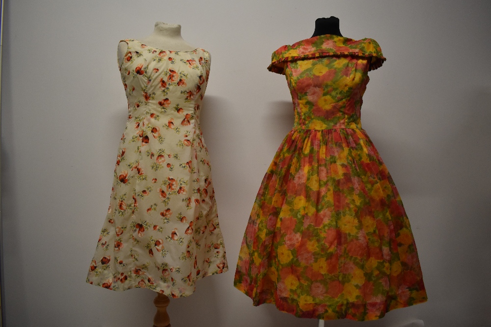 Two 1950s dresses, including vibrant floral dress with full skirt and shawl collar.