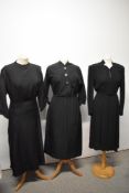 Three black dresses, including black grosgrain dress with novelty beetle buttons and 1940s black