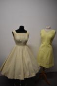 A 1950s full skirted princess cut dress, having gold fleck to cream ground and a lemon yellow