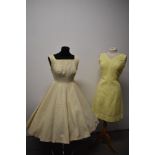 A 1950s full skirted princess cut dress, having gold fleck to cream ground and a lemon yellow