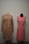 A 1960s tailored pink linen day dress with white stitching and a 1960s knitted green and pink